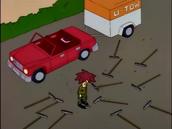 Man standing in a parking lot, surrounded by rakes in every direction, and no ability to walk without smacking himself in the face